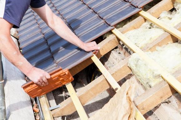 Roofer in York installing roofing tiles